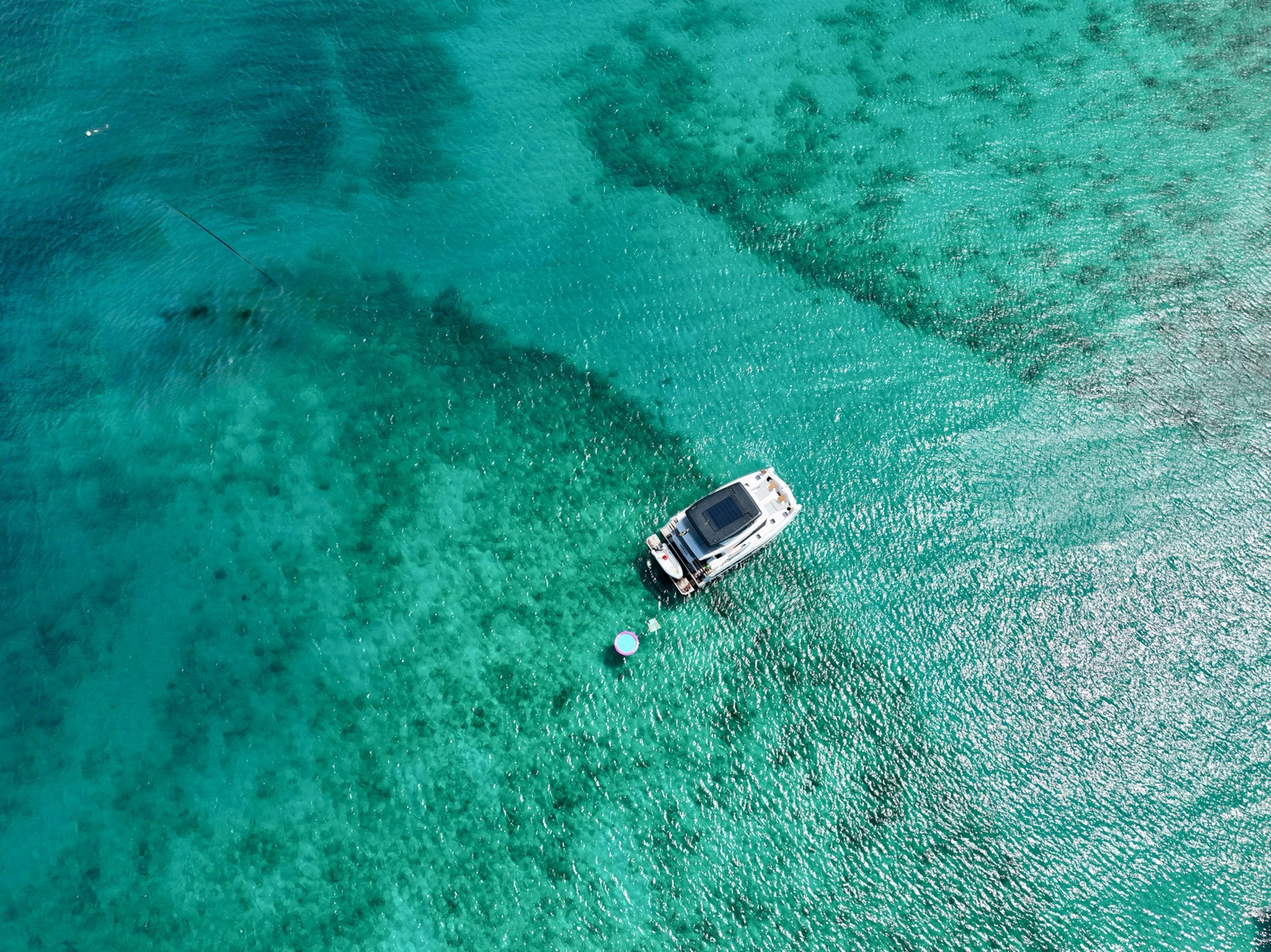 Aerial drone view of Yachti By Nature anchored in turquoise British Virgin Islands water