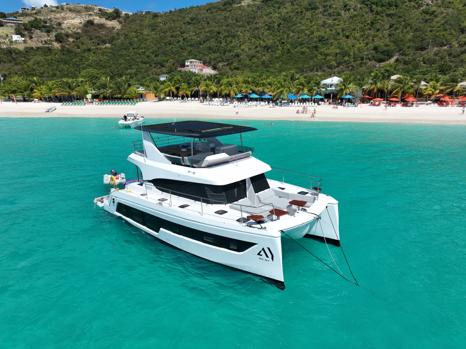 Yachti By Nature anchored near a beach in the British Virgin Islands