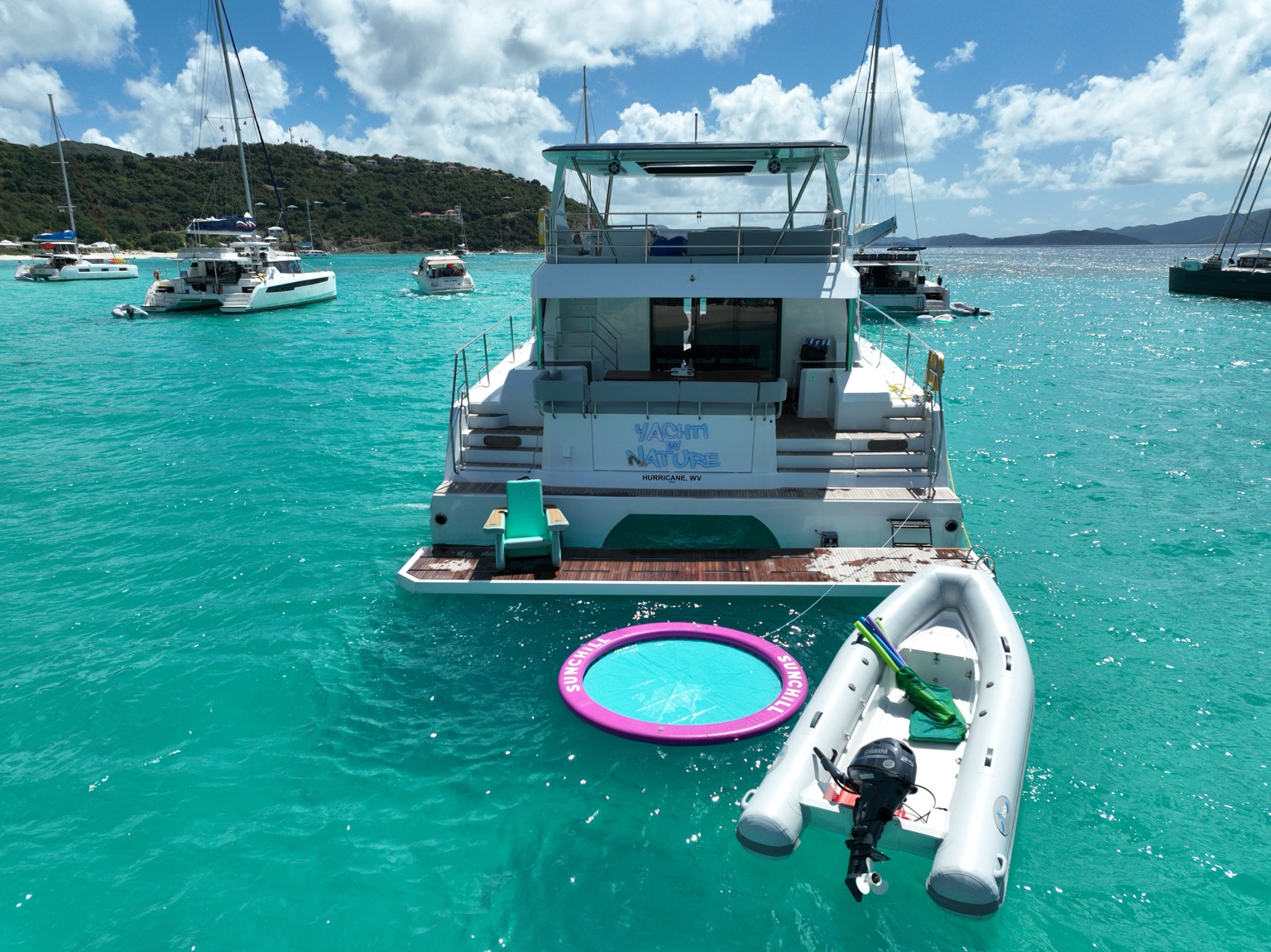 Yachti By Nature stern swim platform with tender and float in clear BVI water